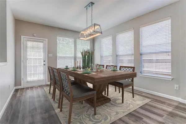 a view of a dining room with furniture window and wooden floor