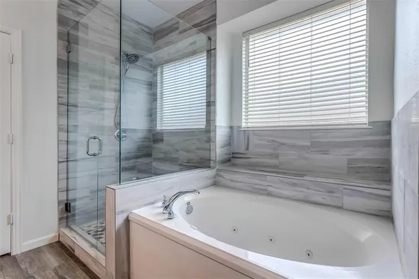 a bath tub sitting next to a window