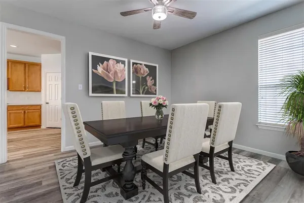 a view of a dining room with furniture and wooden floor