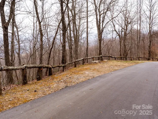 a view of wooden fence and trees