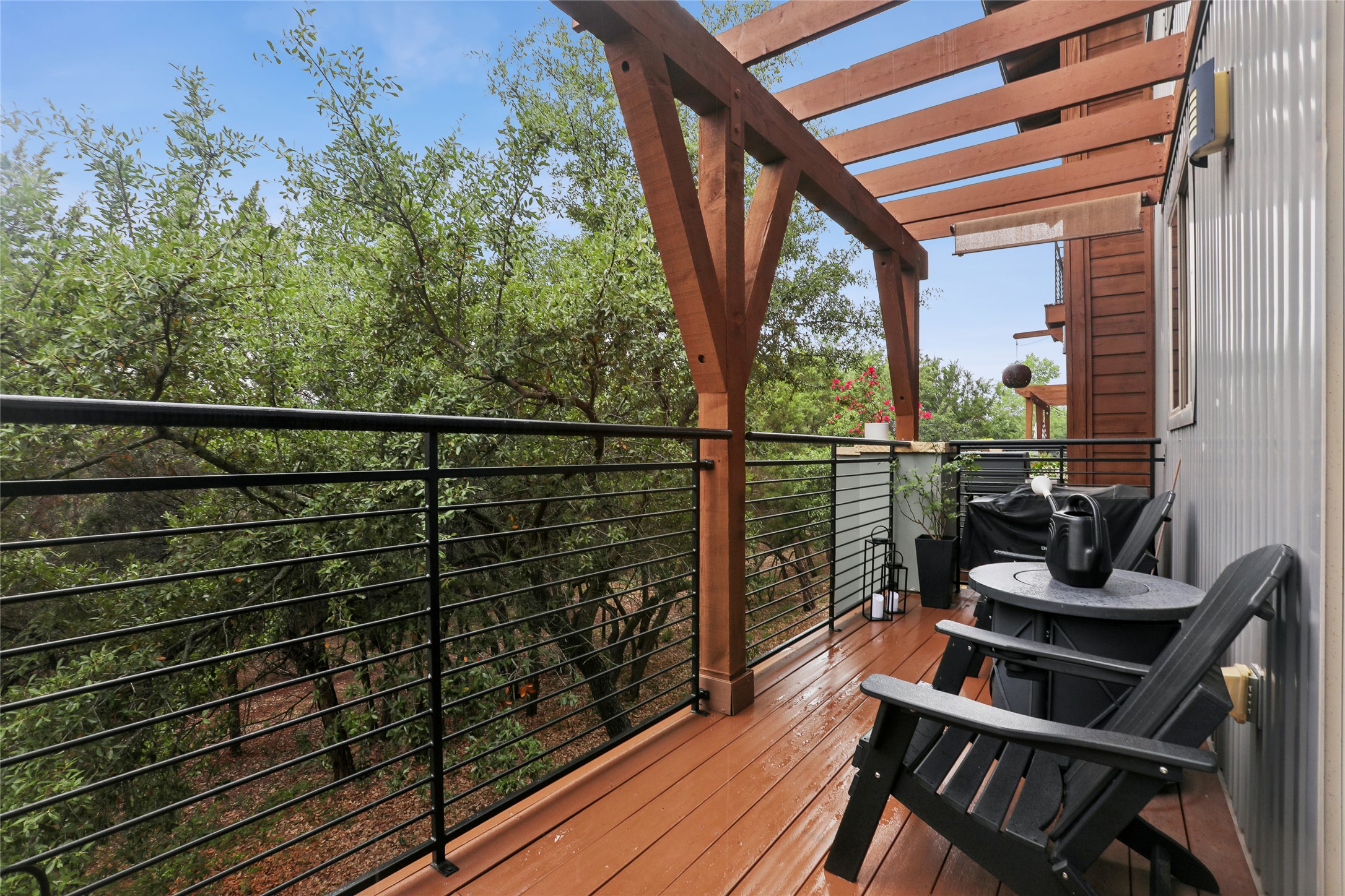 8110 Ranch Road 2222, Unit 10 Austin, TX 78730 - Photo 17 of 23 a view of a balcony with chairs and wooden floor