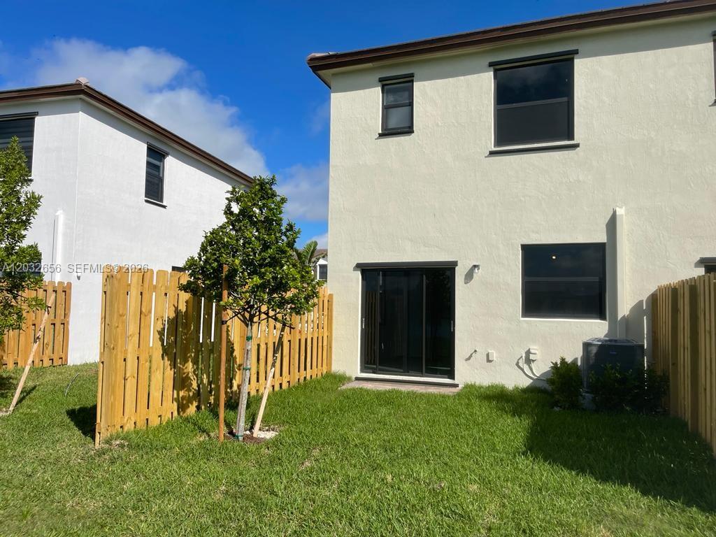 10144 Southwest 228th Terrace Miami, FL 33190 - Photo 23 of 23 a view of a house with backyard and a garden