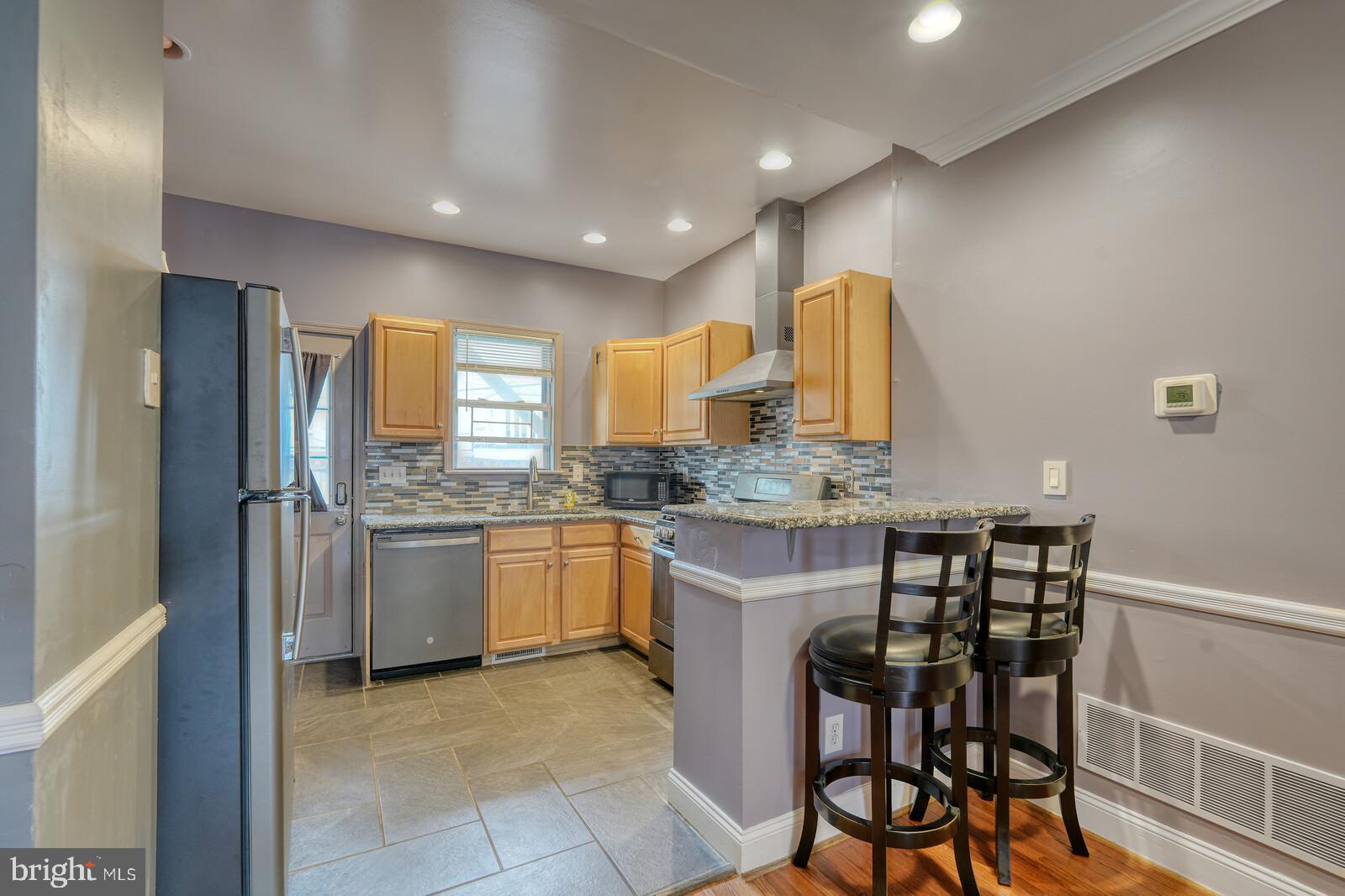 1212 Marshall Street Baltimore, MD 21230 - Photo 13 of 39 a kitchen with stainless steel appliances granite countertop a sink and a refrigerator