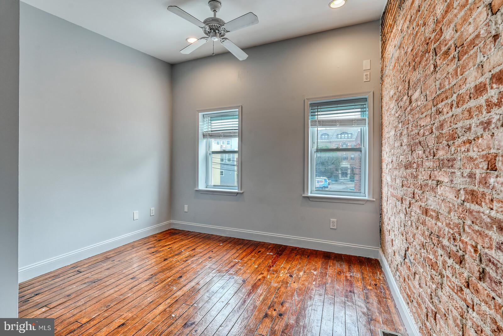 1212 Marshall Street Baltimore, MD 21230 - Photo 17 of 39 wooden floor in an empty room with a window