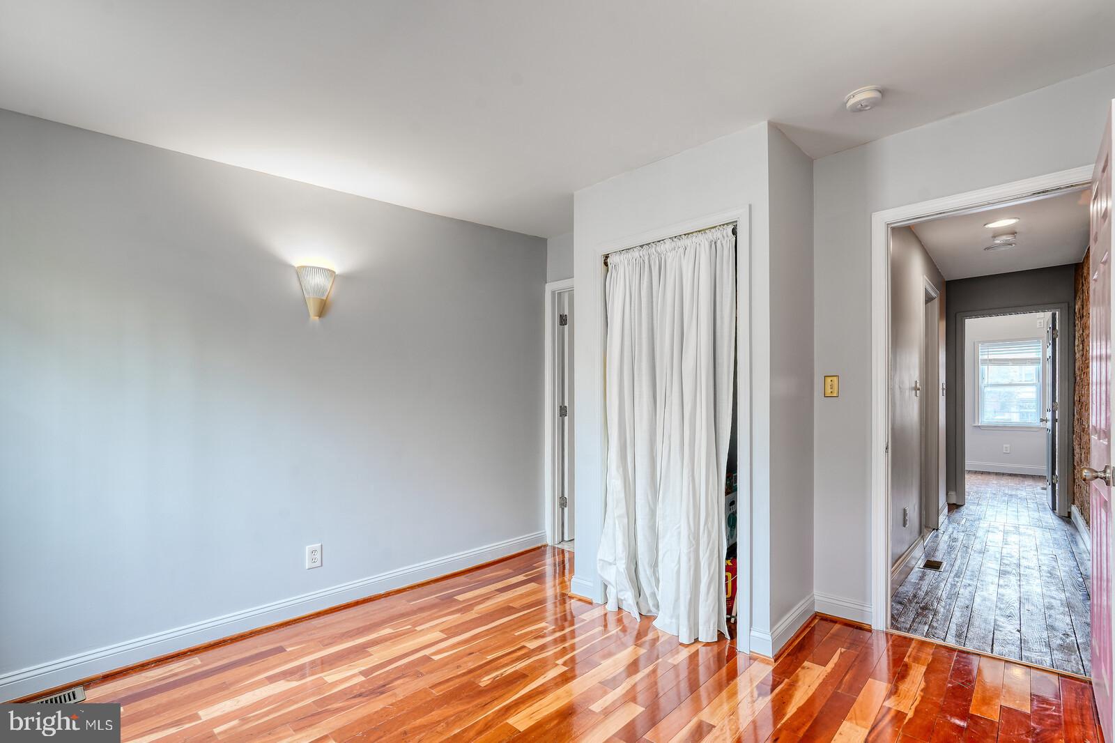 1212 Marshall Street Baltimore, MD 21230 - Photo 18 of 39 wooden floor in an empty room with a window