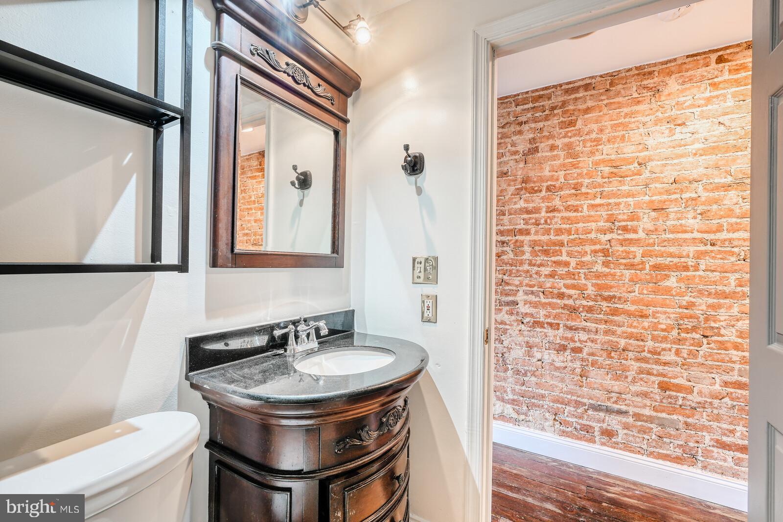 1212 Marshall Street Baltimore, MD 21230 - Photo 20 of 39 a bathroom with a sink toilet and mirror