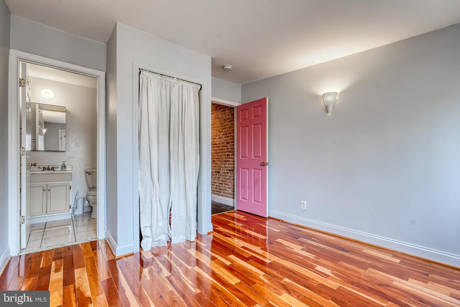 1212 Marshall Street Baltimore, MD 21230 - Photo 22 of 39 an empty room with a fireplace and windows