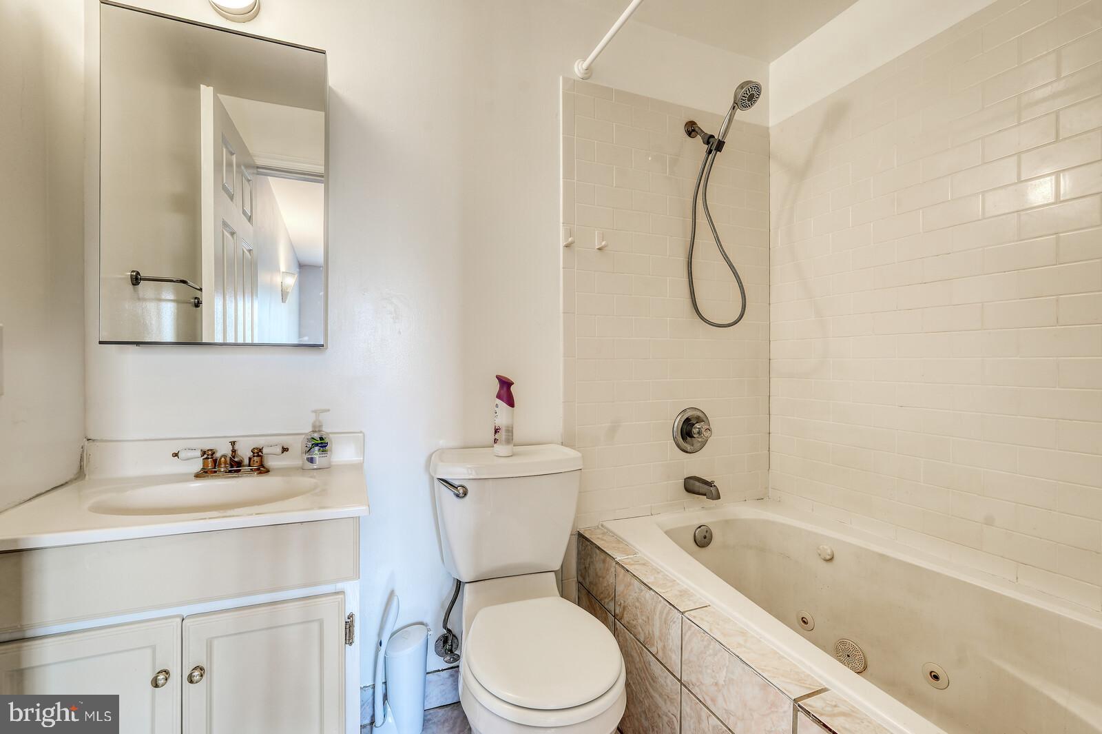 1212 Marshall Street Baltimore, MD 21230 - Photo 24 of 39 a bathroom with a sink toilet vanity and shower