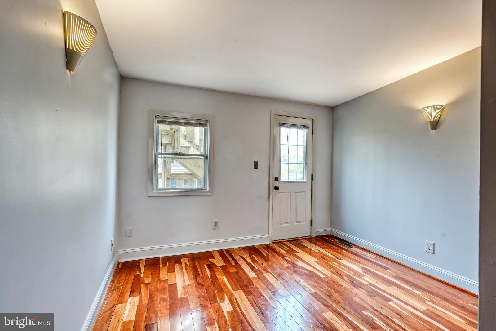1212 Marshall Street Baltimore, MD 21230 - Photo 26 of 39 a view of empty room with window and wooden floor