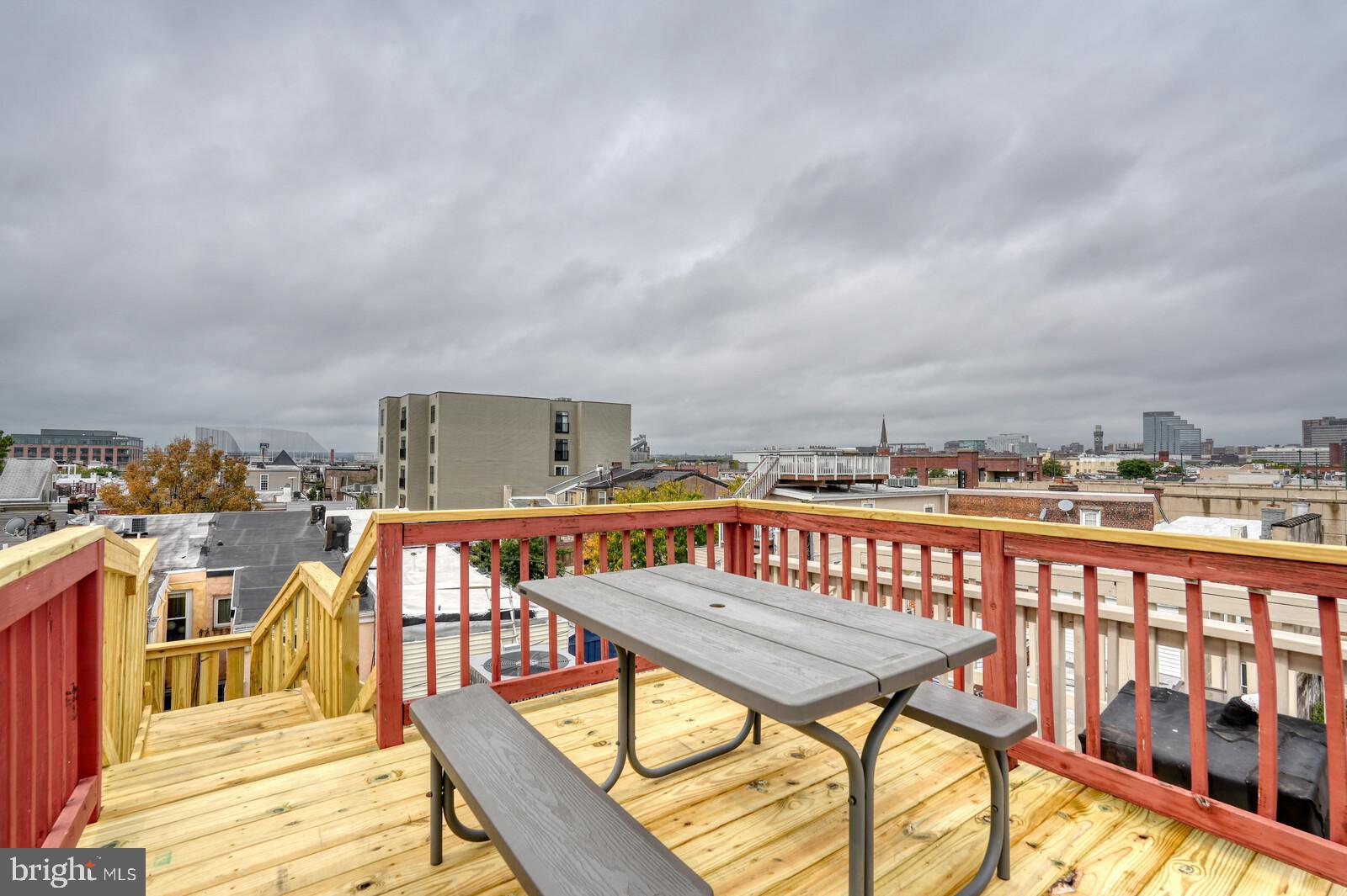 1212 Marshall Street Baltimore, MD 21230 - Photo 30 of 39 a balcony with a table and chairs