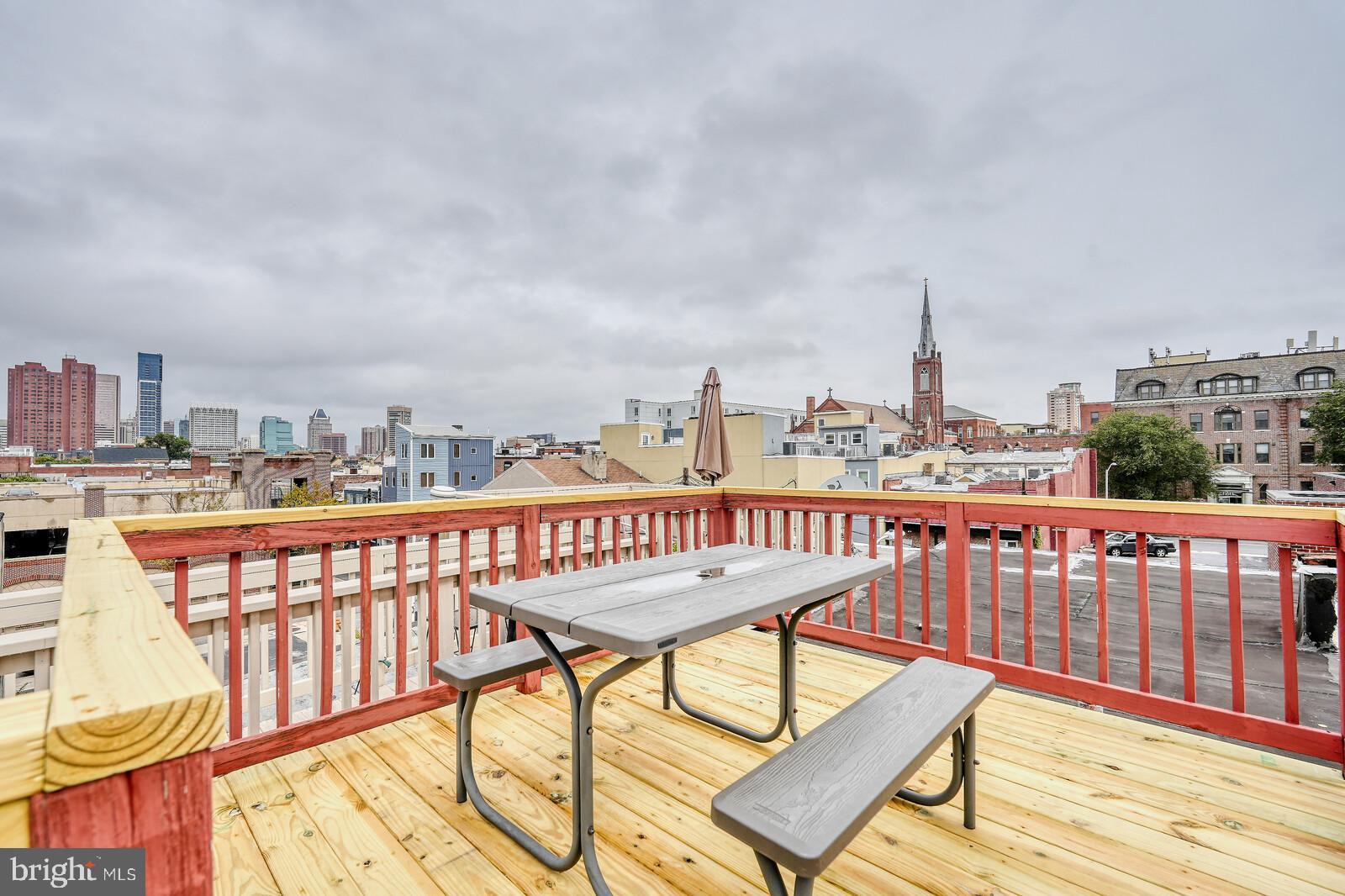 1212 Marshall Street Baltimore, MD 21230 - Photo 33 of 39 a view of a roof deck with two chairs and wooden floor