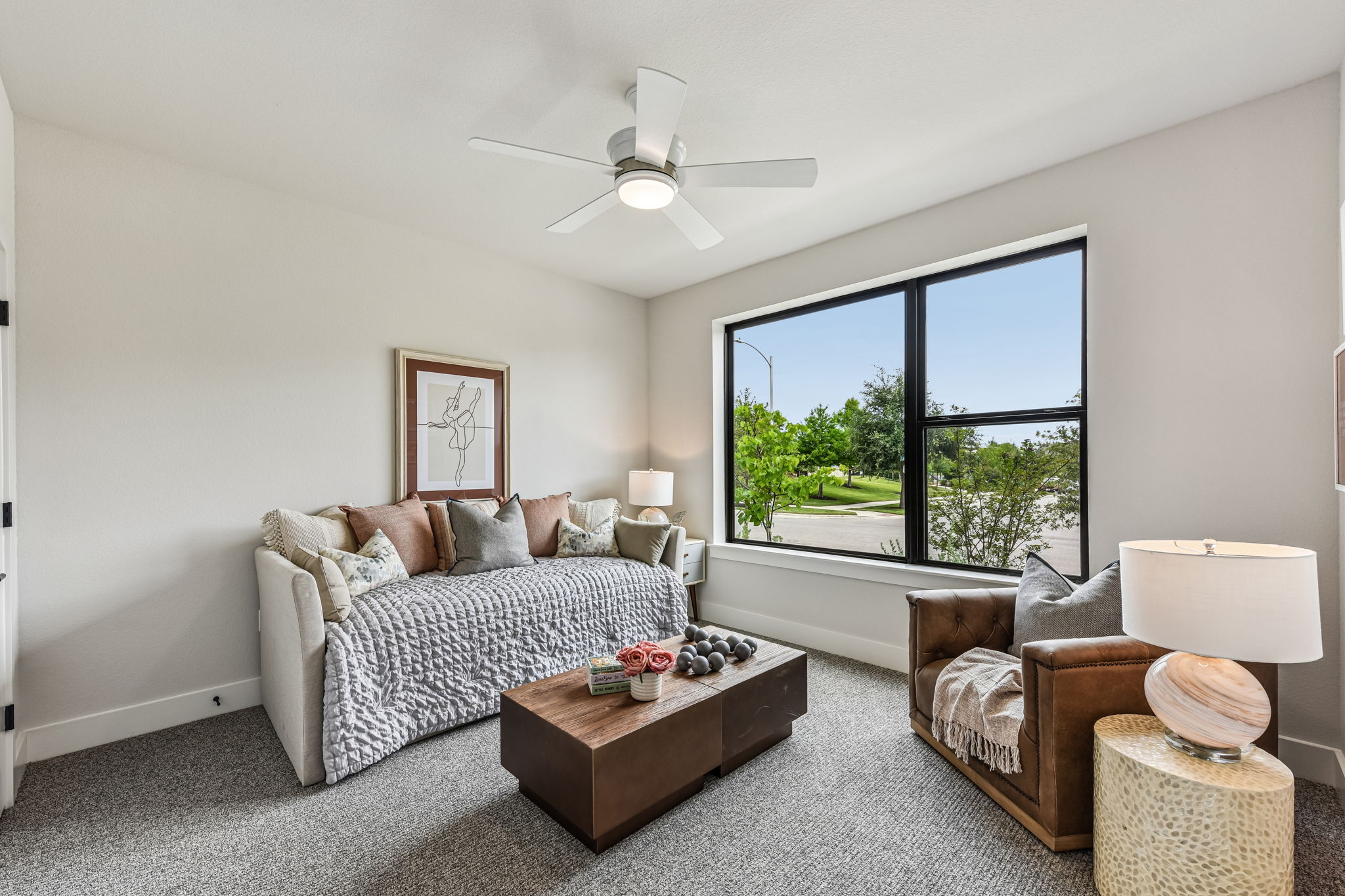9033 Cattle Baron Path Austin, TX 78747 - Photo 15 of 40 A quiet retreat with plush carpeting and a large window overlooking the vibrant neighborhood.
