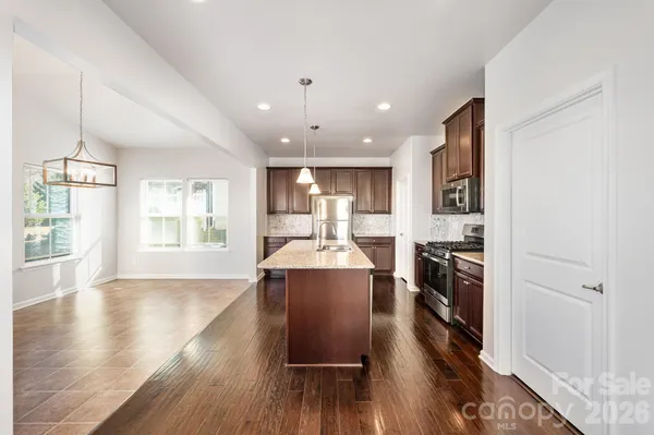 a view of kitchen with sink and wooden floor