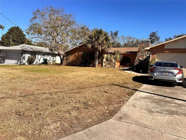 a view of a car park in front of a house