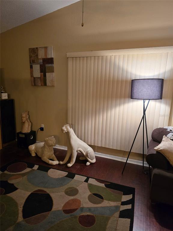 140 Callaway Avenue Spring Hill, FL 34606 - Photo 7 of 16 a living room with furniture and a lamp