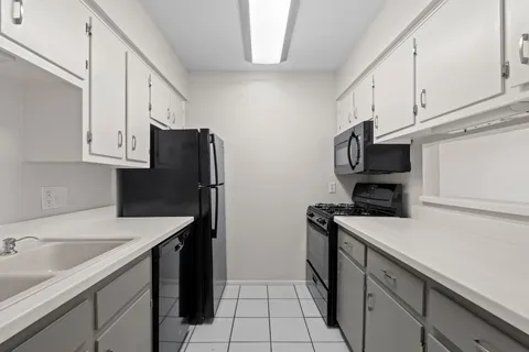 a kitchen with appliances cabinets and a sink