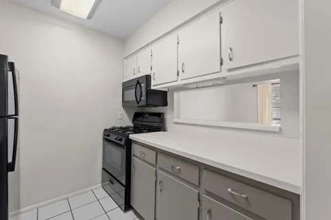 a utility room with cabinets washer and dryer