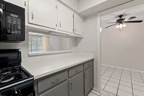 a kitchen with a stove and a microwave
