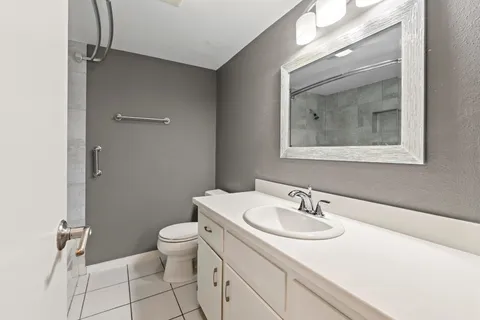 a bathroom with a sink toilet and a mirror