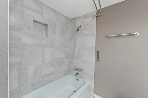 a bathroom with a bathtub and shower