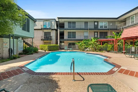 a view of building with a swimming pool