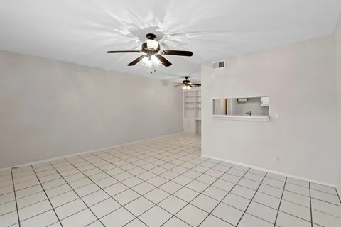 a view of a room with window and ceiling fan