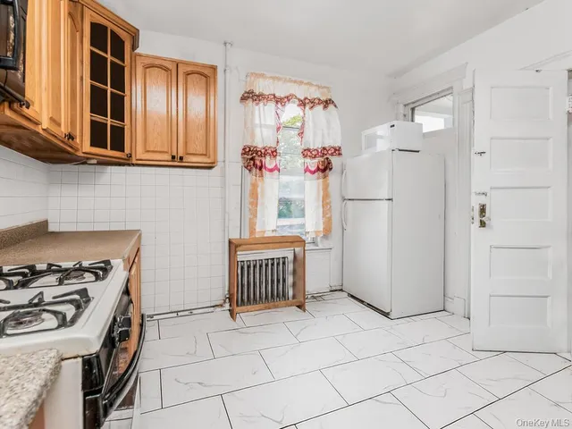 a kitchen with stainless steel appliances granite countertop a refrigerator and a stove