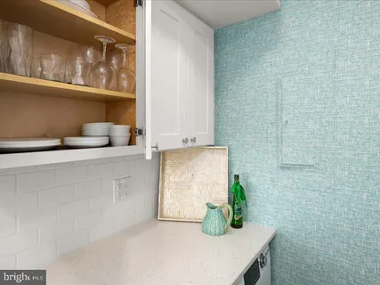 a kitchen with stainless steel appliances kitchen island granite countertop a refrigerator and a dining table