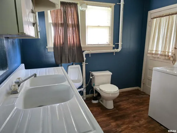 a white toilet sitting next to a bathroom sink