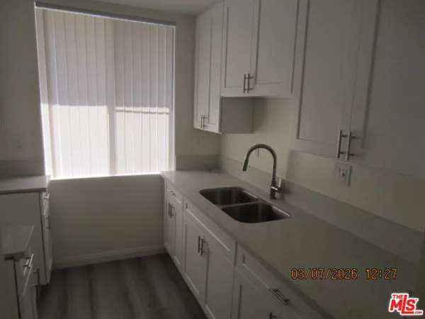 a kitchen with a sink and cabinets
