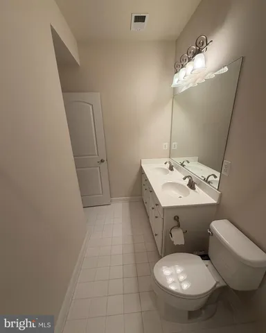 a bathroom with a sink toilet and mirror