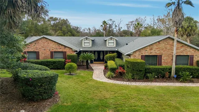 a view of a house with pool and garden