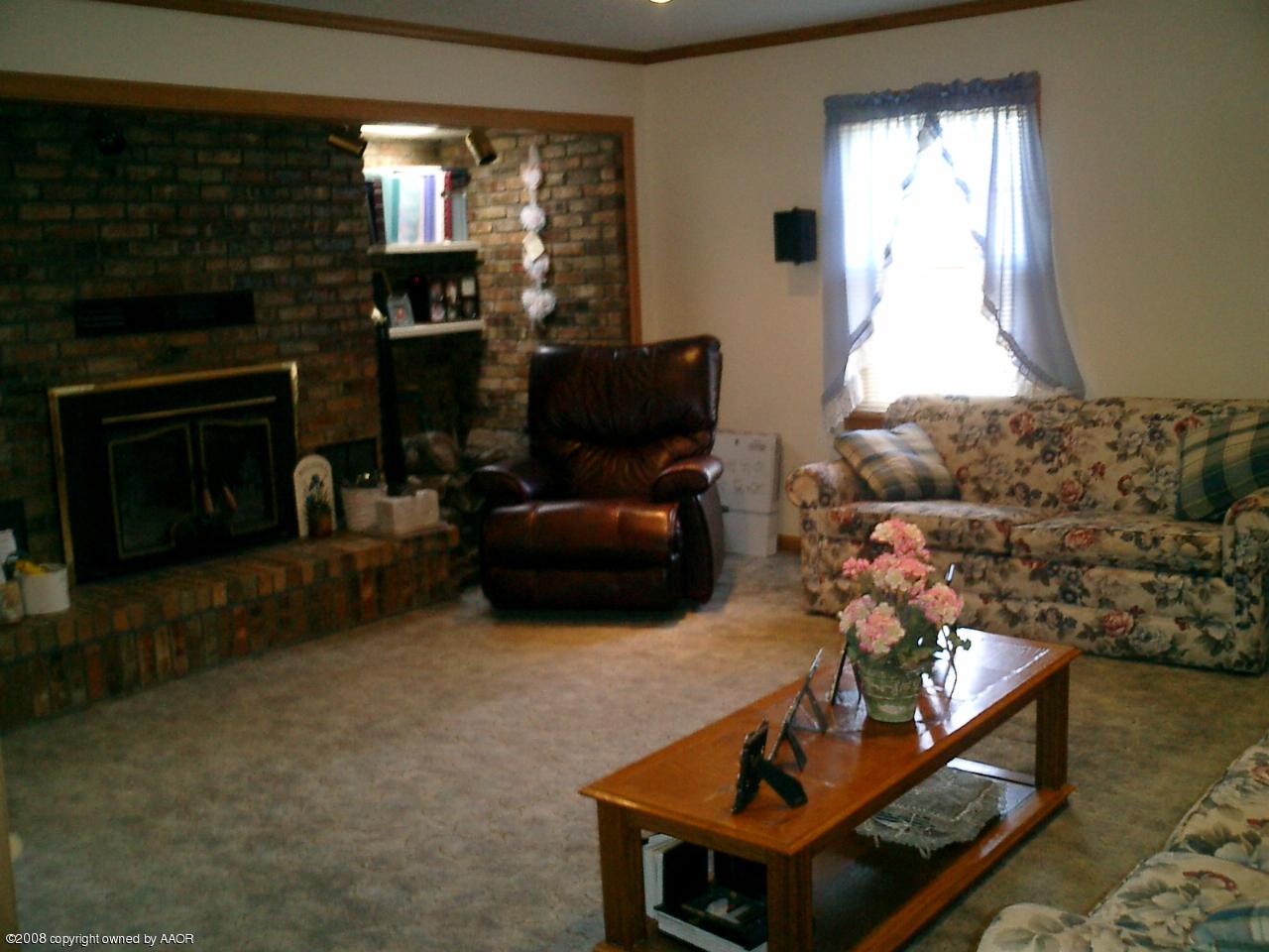 4319 South Hayden Street Amarillo, TX 79110 - Photo 2 of 13 a living room with furniture and a fireplace