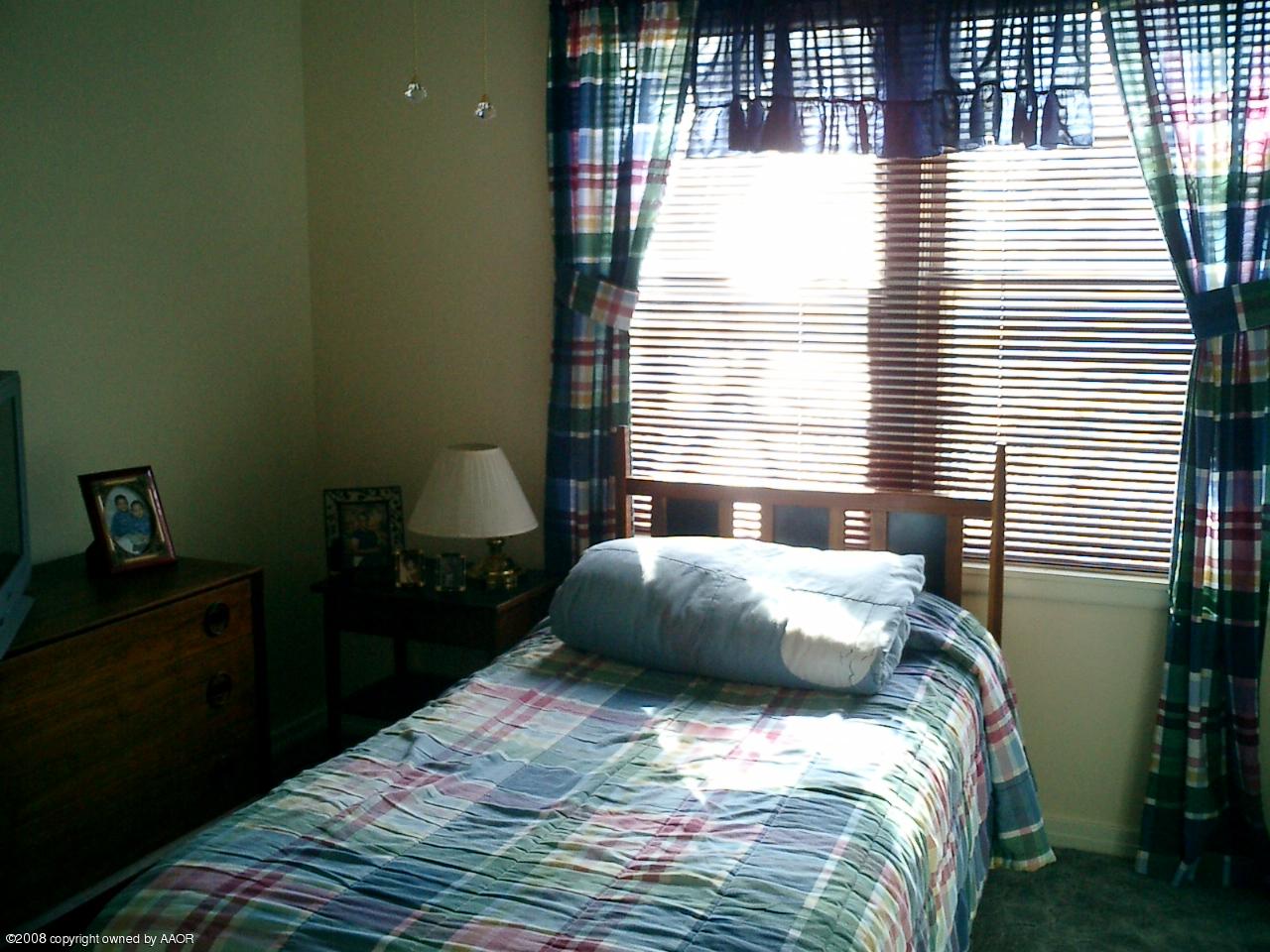 4319 South Hayden Street Amarillo, TX 79110 - Photo 5 of 13 a bedroom with a bed and a window