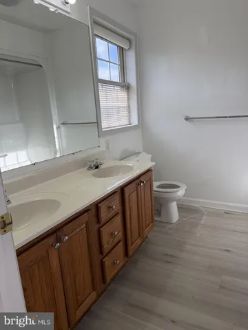 a bathroom with a sink a toilet and mirror
