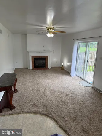wooden floor in an empty room with a fireplace