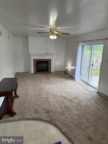 wooden floor in an empty room with a fireplace