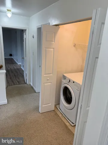a view of a hallway and a washer and dryer