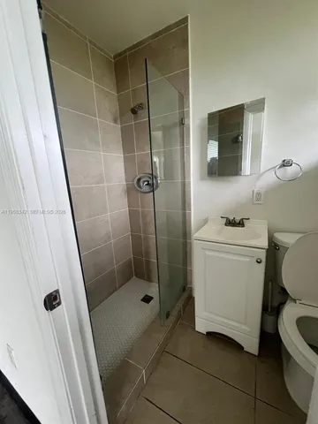 a bathroom with a shower toilet and sink
