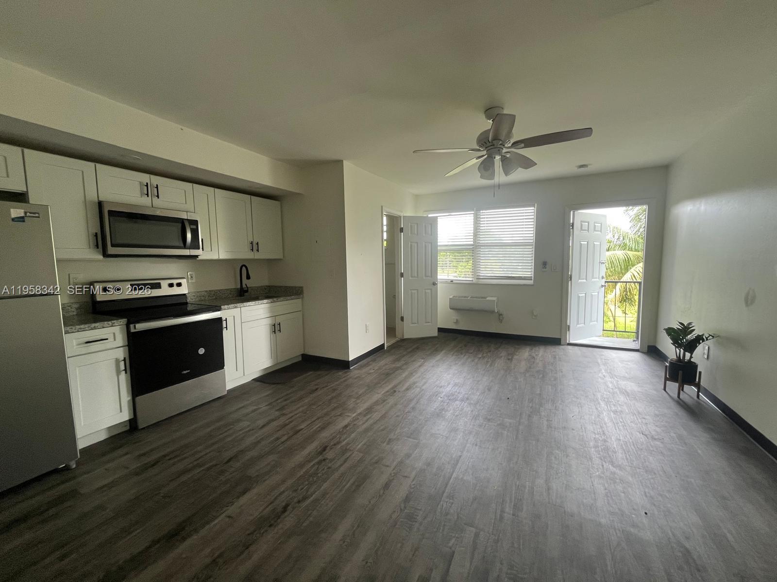 467 Northwest 8th Street, Unit 14 Miami, FL 33136 - Photo 2 of 13 a view of kitchen with sink a microwave and stove