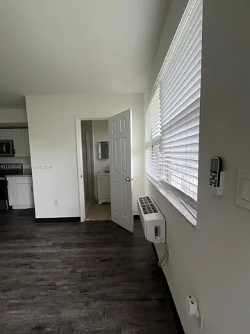 a view of a hallway with the wooden floor and staircase