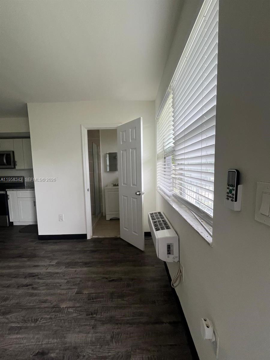 467 Northwest 8th Street, Unit 14 Miami, FL 33136 - Photo 7 of 13 a view of a hallway with the wooden floor and staircase