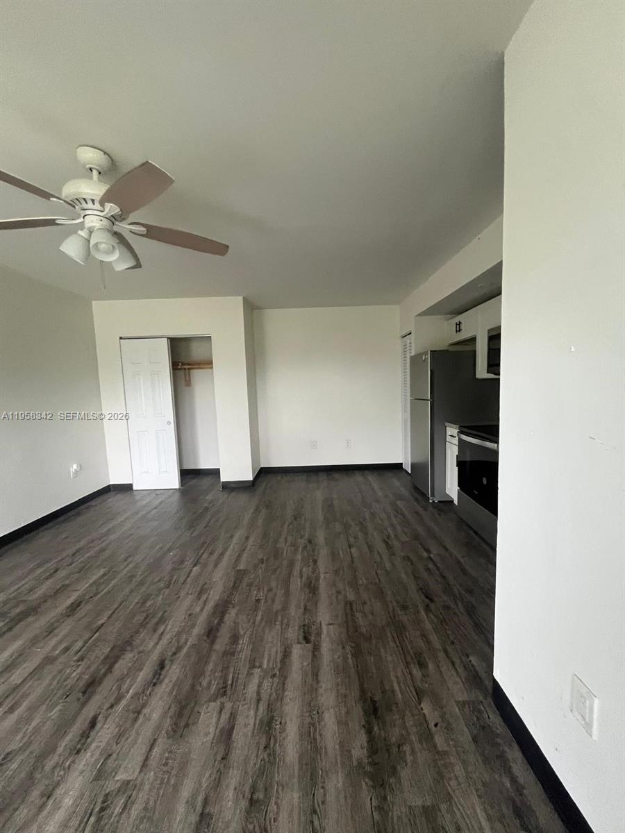 467 Northwest 8th Street, Unit 14 Miami, FL 33136 - Photo 8 of 13 wooden floor in an empty room with a window