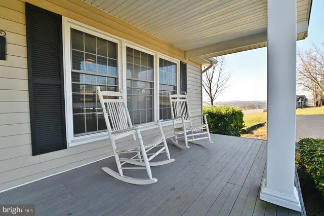 a view of a balcony with wooden floor and fence