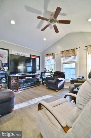 a bedroom with a large bed and wooden floor
