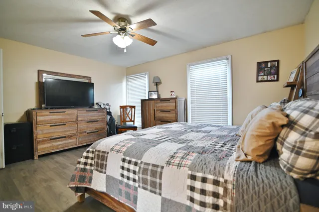 a bed sitting in a bedroom next to a bathroom