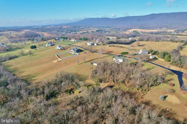an aerial view of a house with garden space and street view