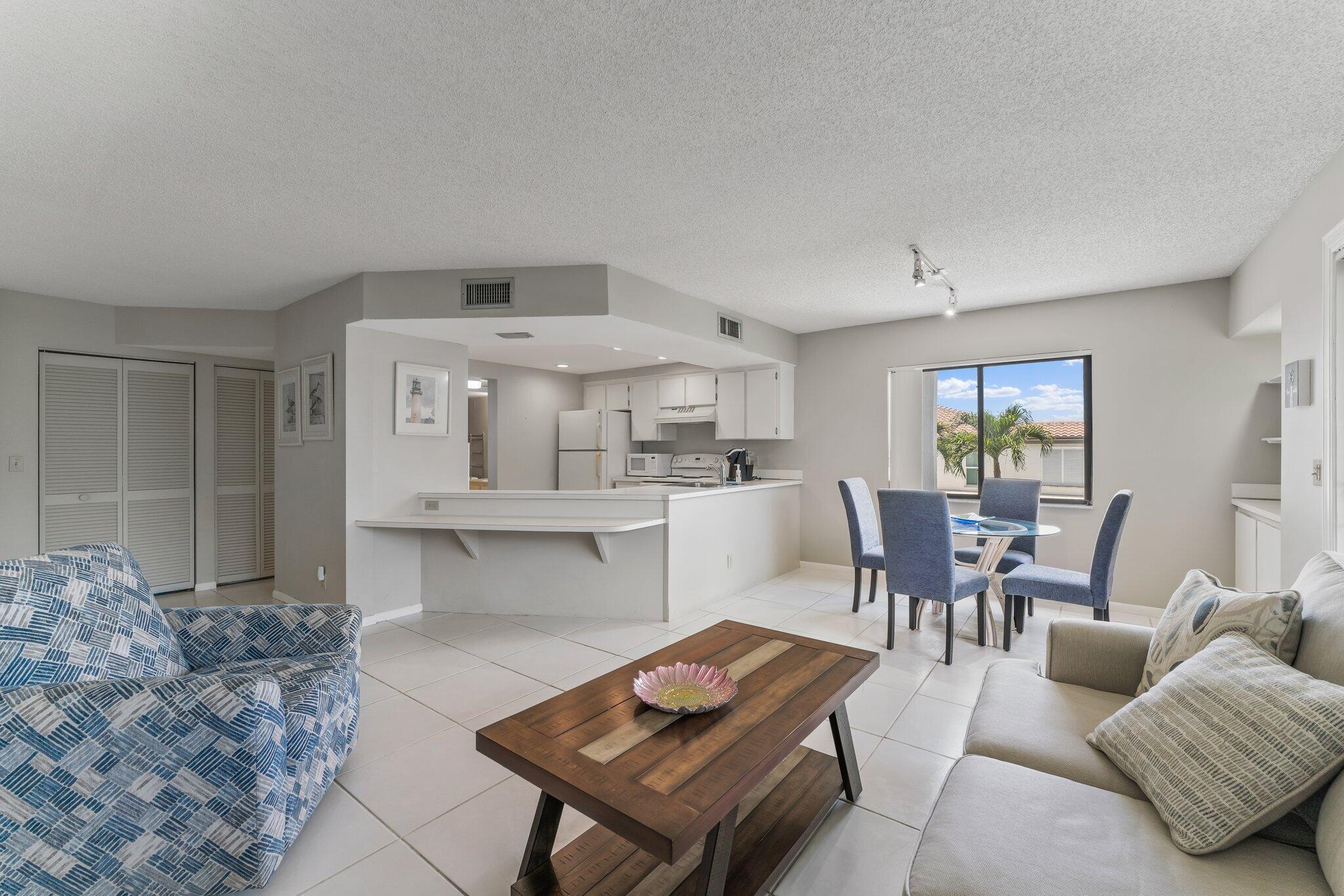 1605 Highway 1, Unit D301 Jupiter, FL 33477 - Photo 12 of 46 a living room with furniture and a wooden floor