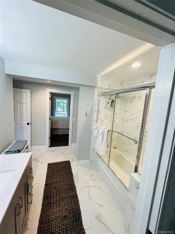 a bathroom with a sink a mirror and a shower