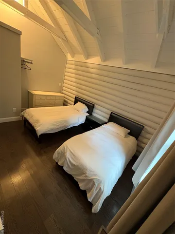 a bedroom with two beds and painted walls